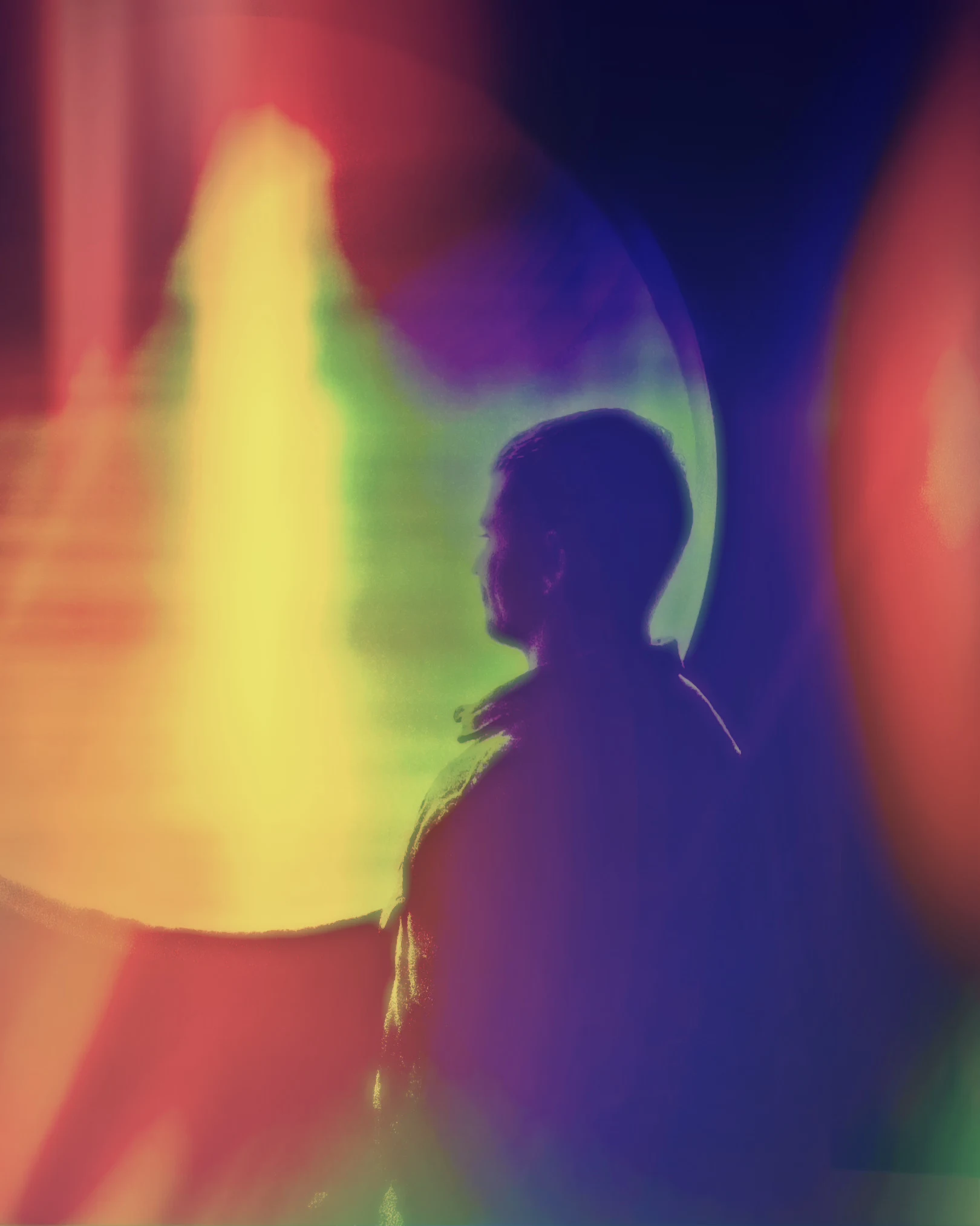 Profile silhouette of a hermz framed by vibrant yellow, violet, and red light refractions.