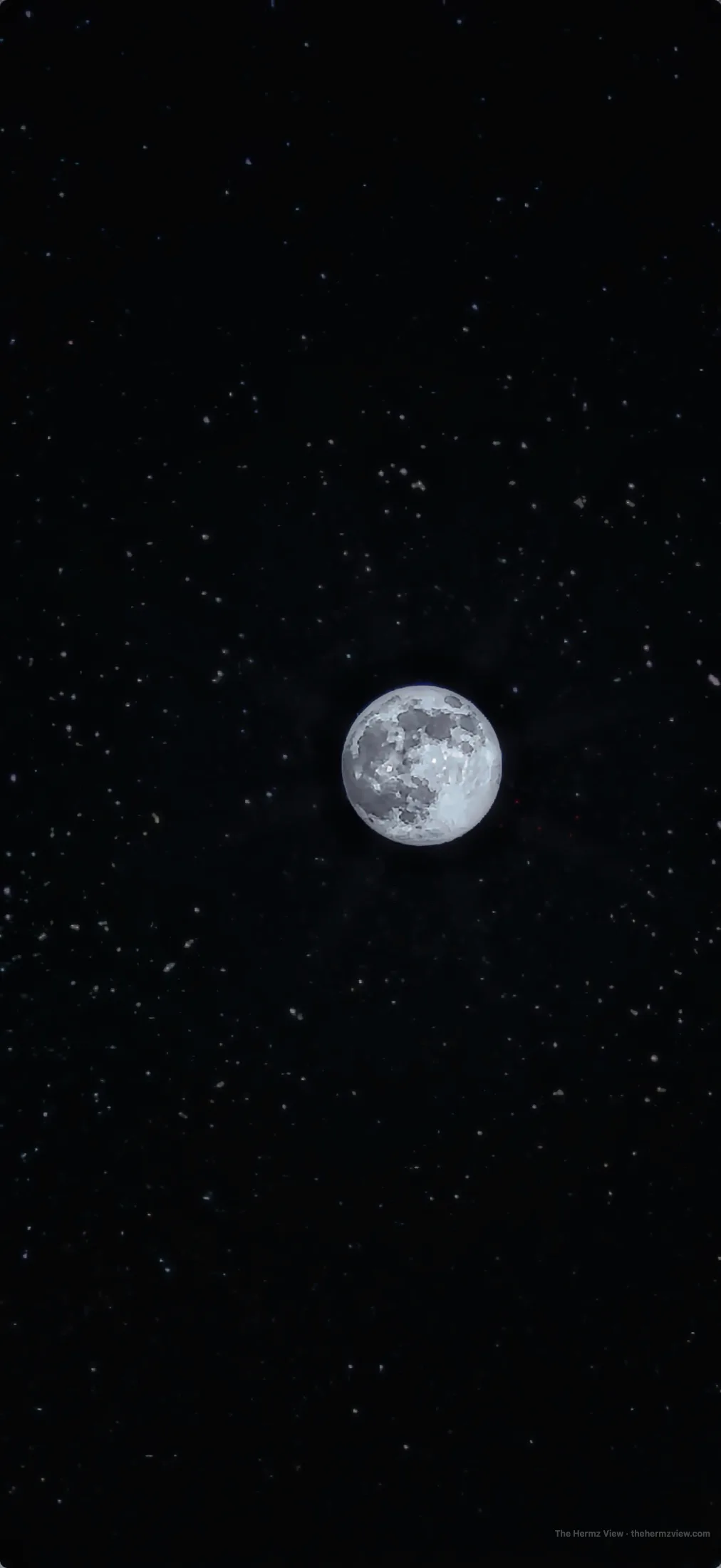 Detailed full moon surrounded by small faint stars against a black night sky.